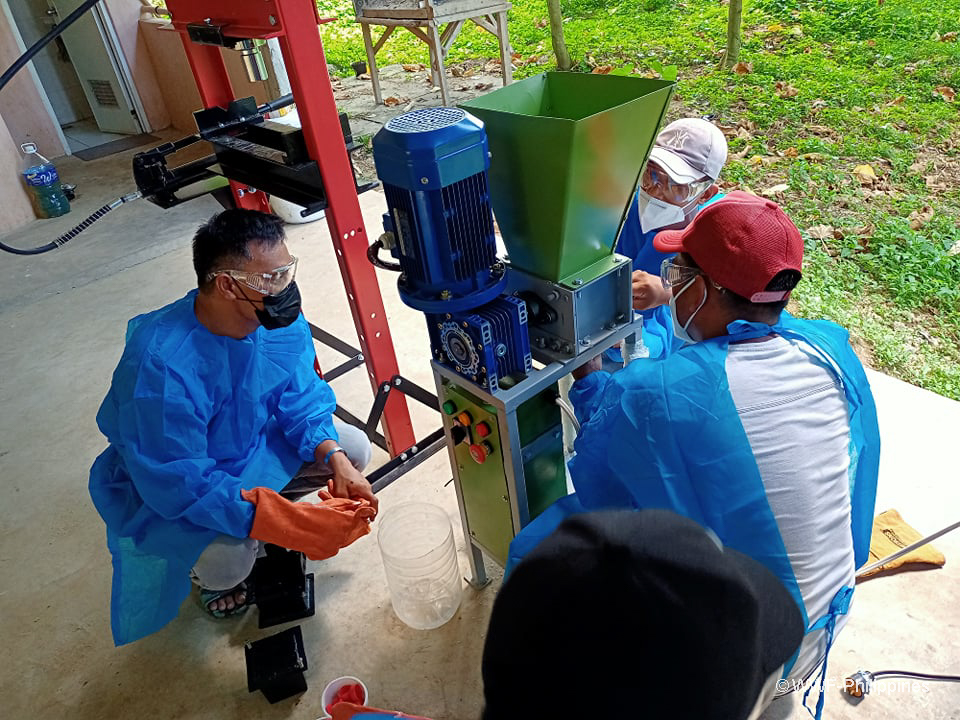 3 - Volunteers operate the plastic shredder machine at the Central Materials Recovery Facility